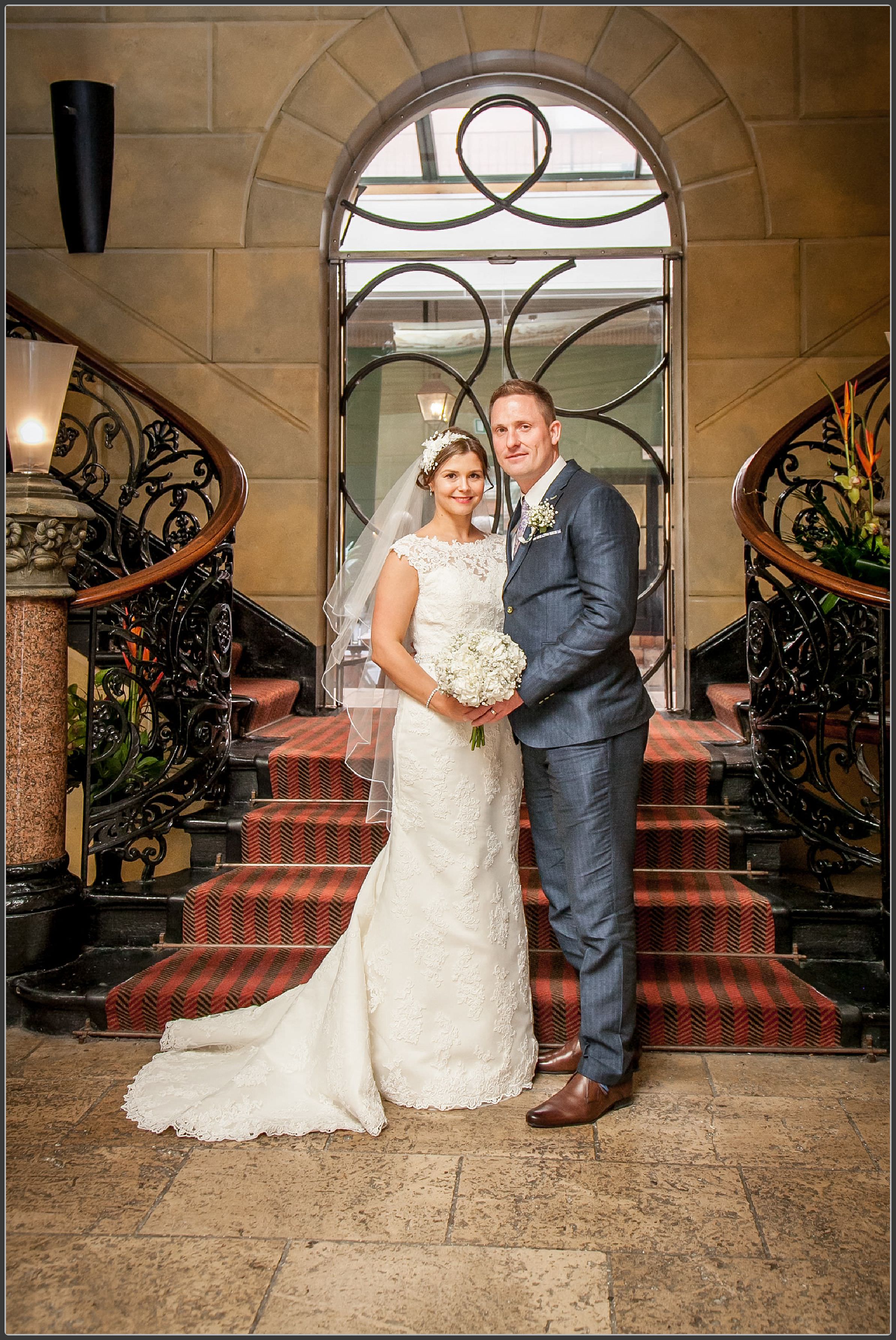 Bride and groom together by the stairs