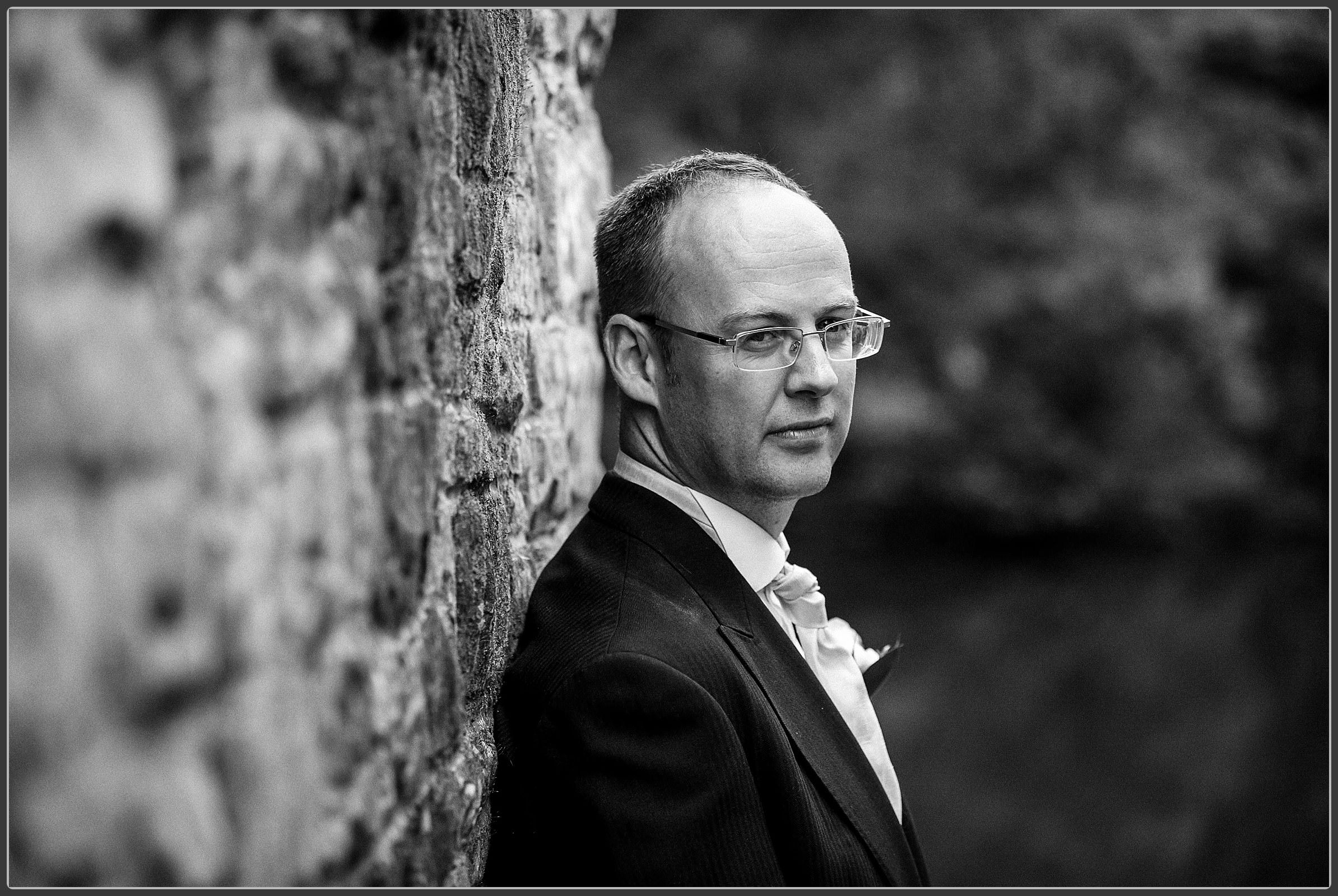 A black and white portrait of the groom