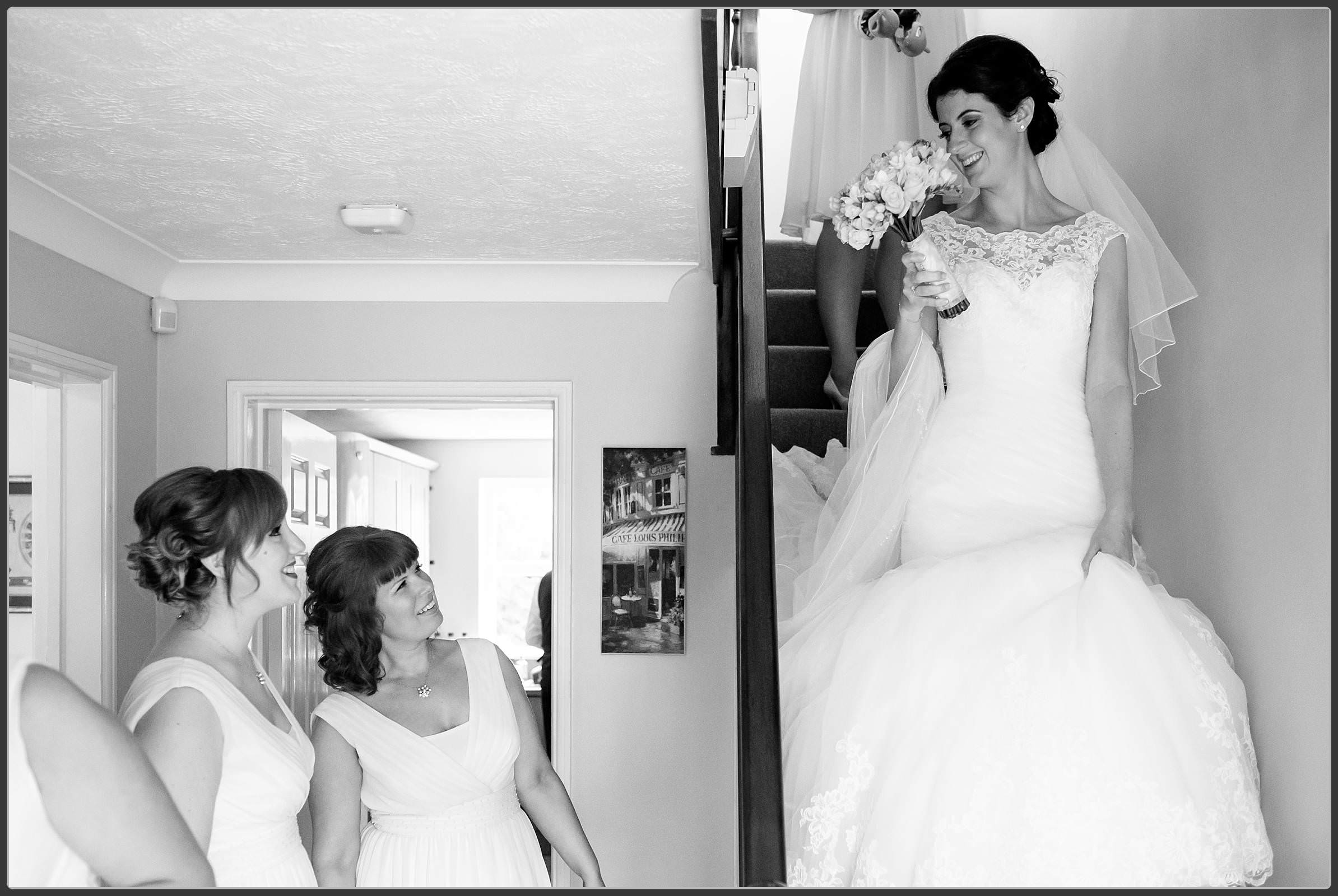 The bride walking down the stairs in black and white