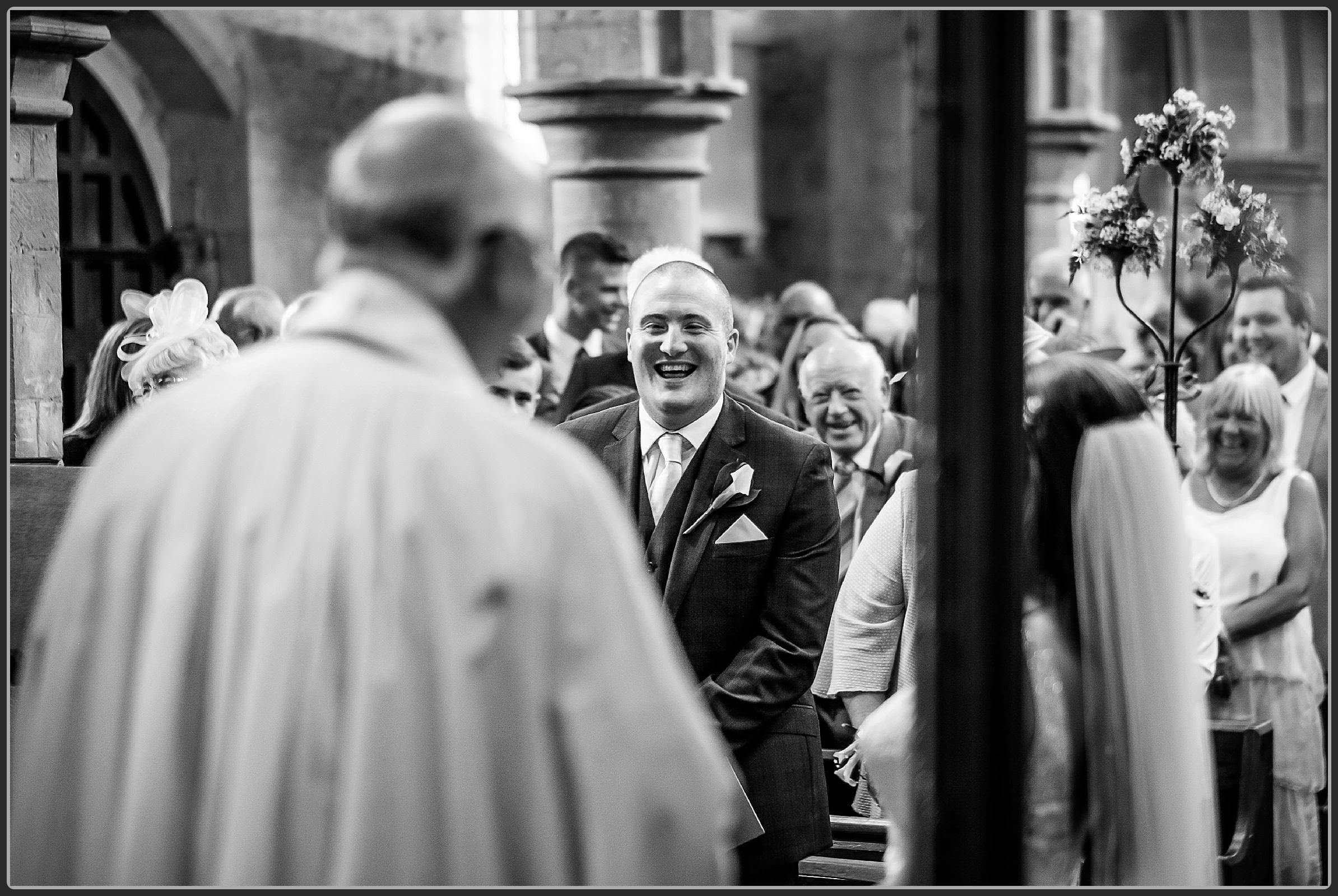 Grooms best man laughing during the ceremony