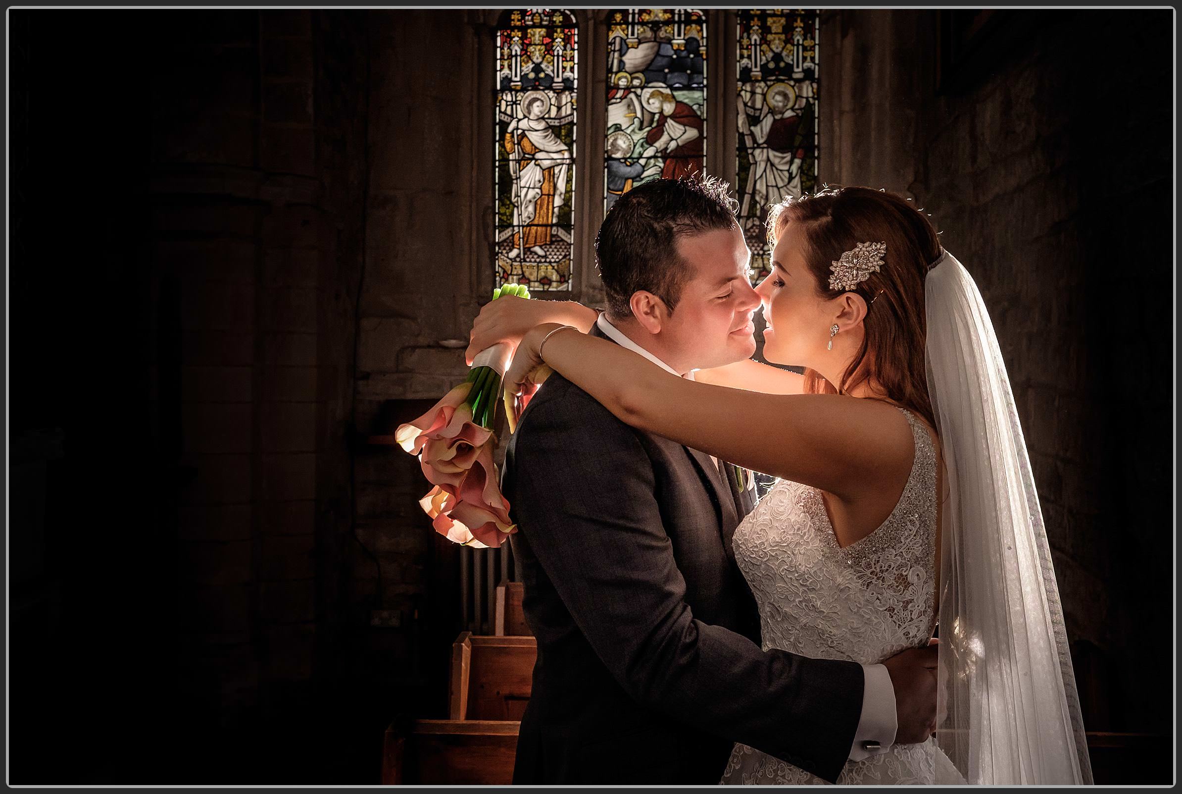 Bride and groom sharing a kiss in the church