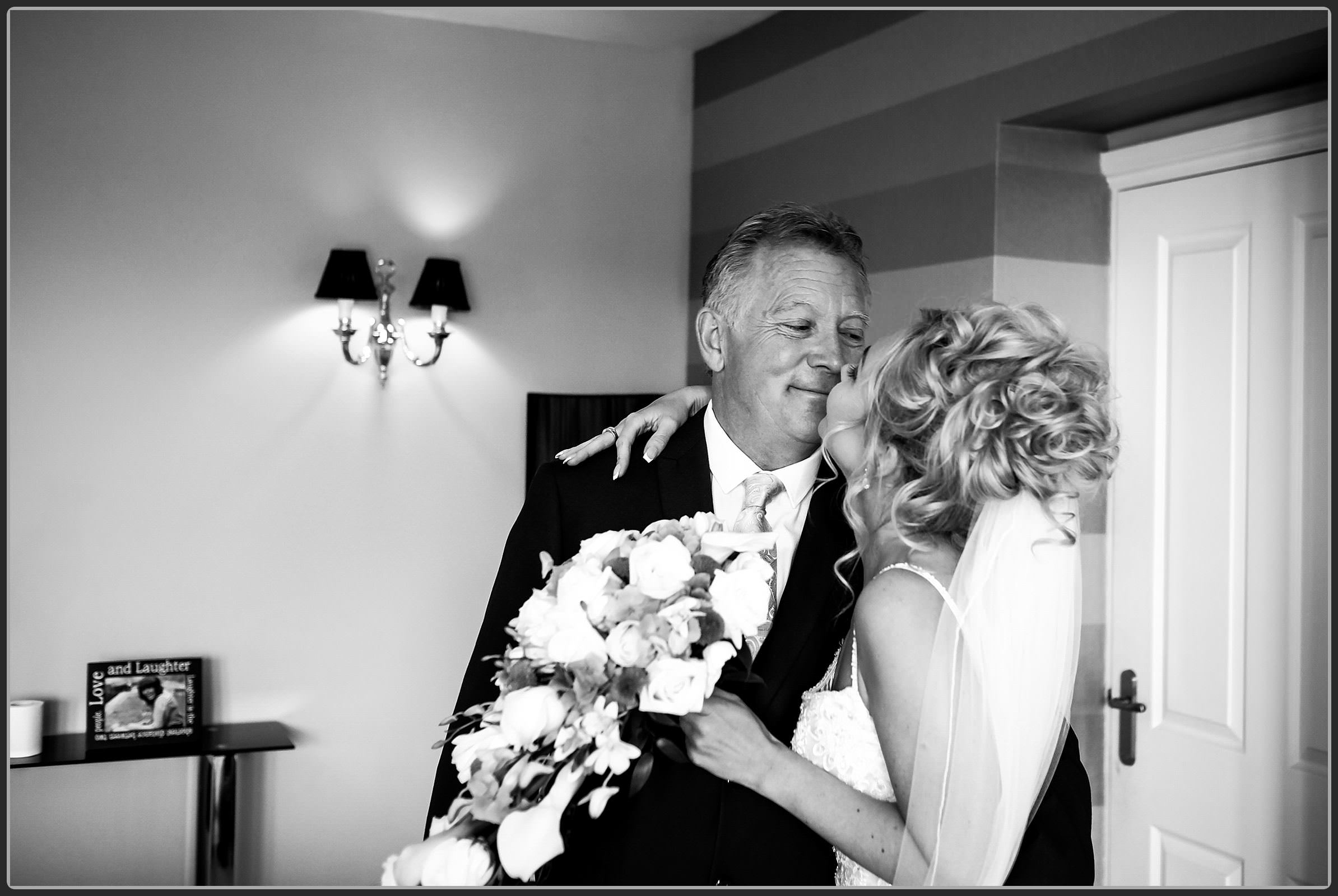 Dad hugging his daughter before the wedding