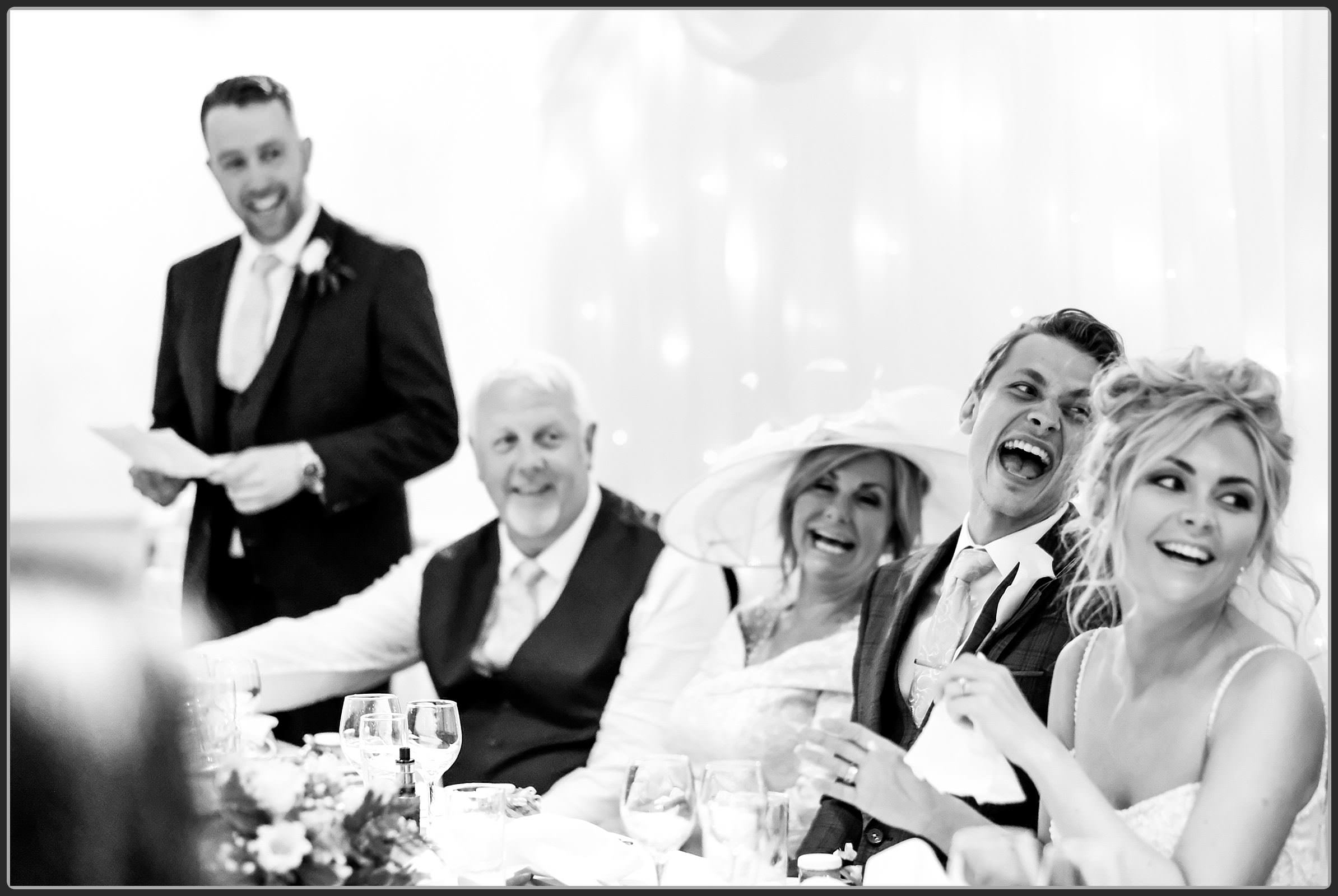 Groom laughing during the speeches