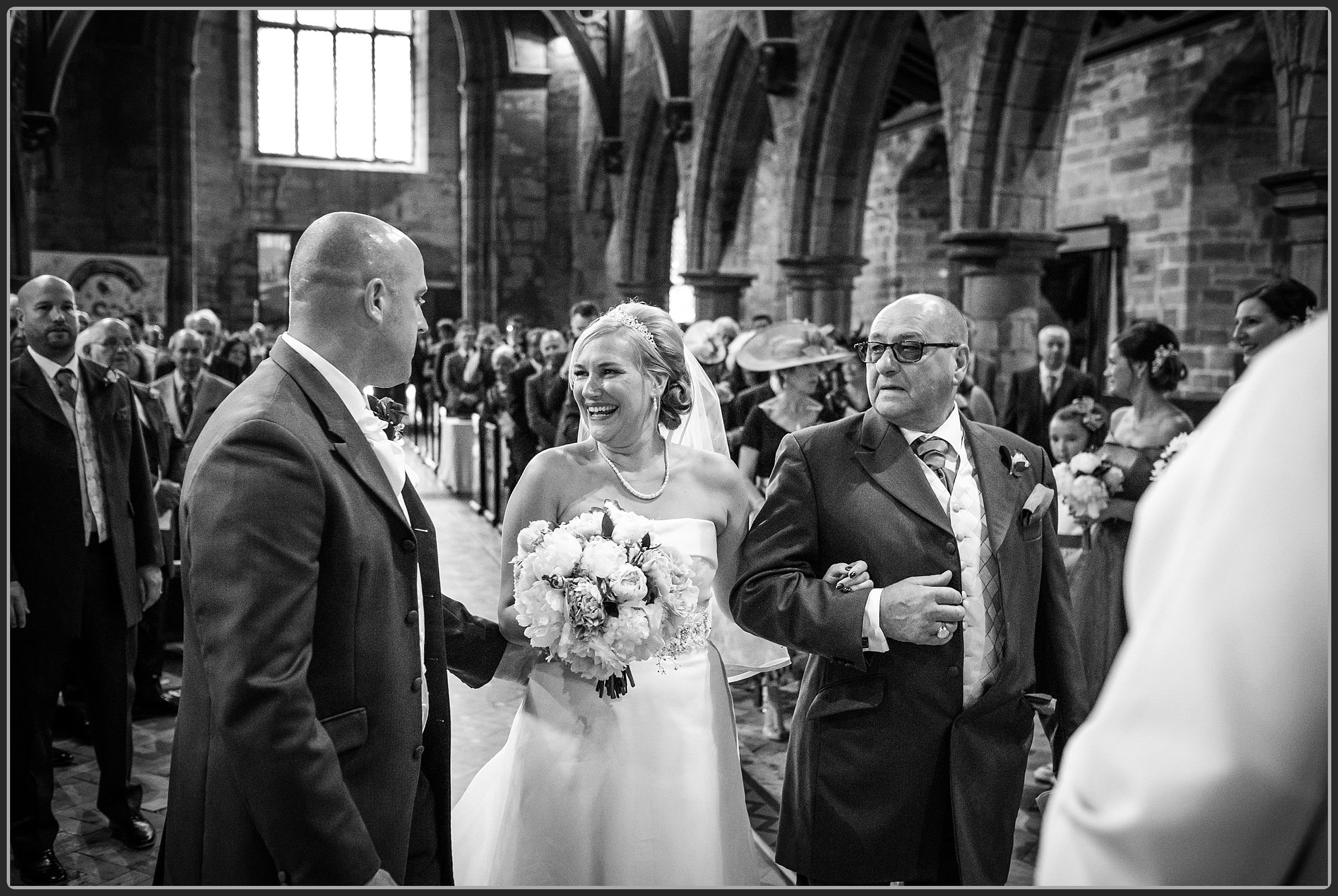 Bride and her father walking down the aisle at St Nicholas church