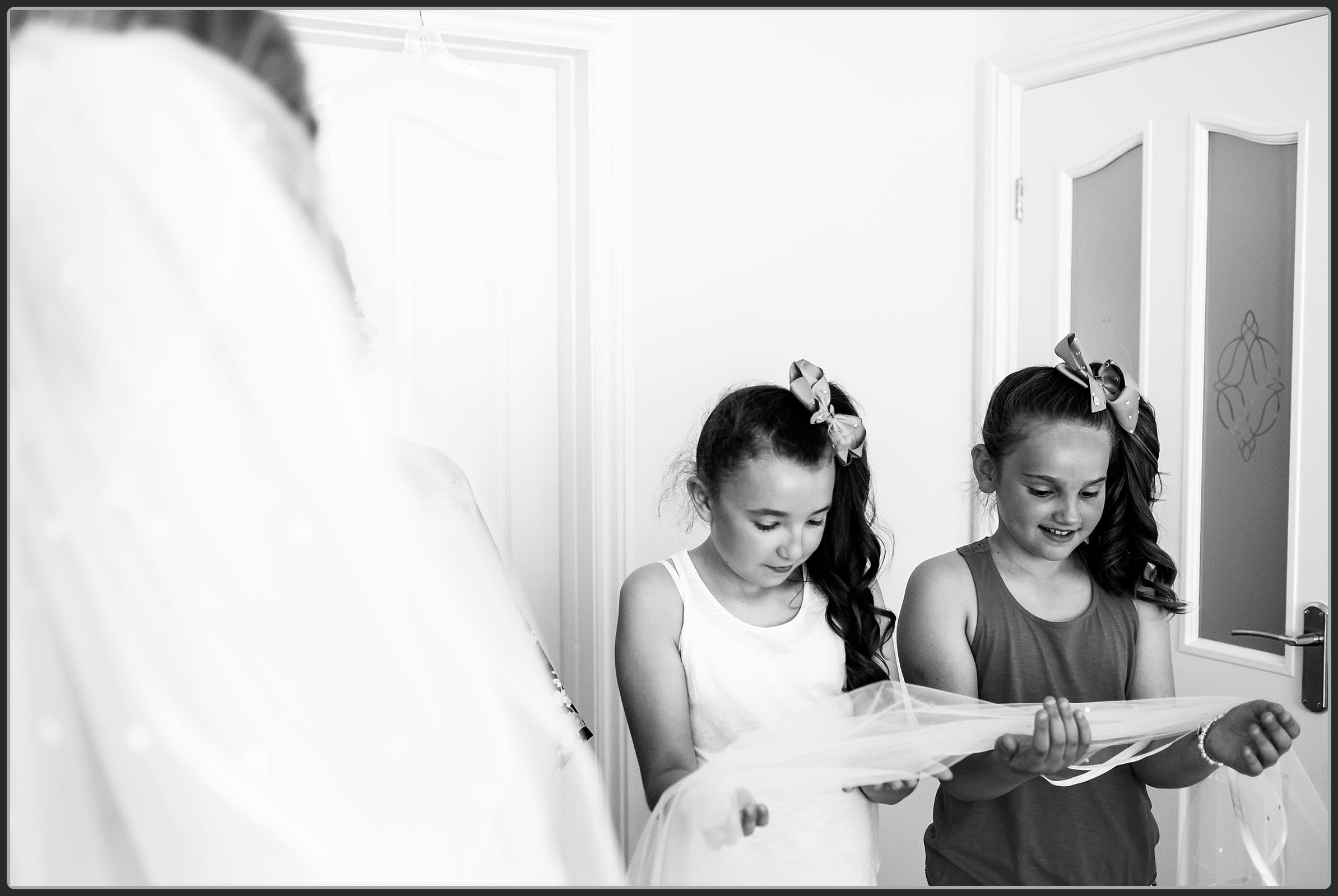 Flower girls with the brides veil