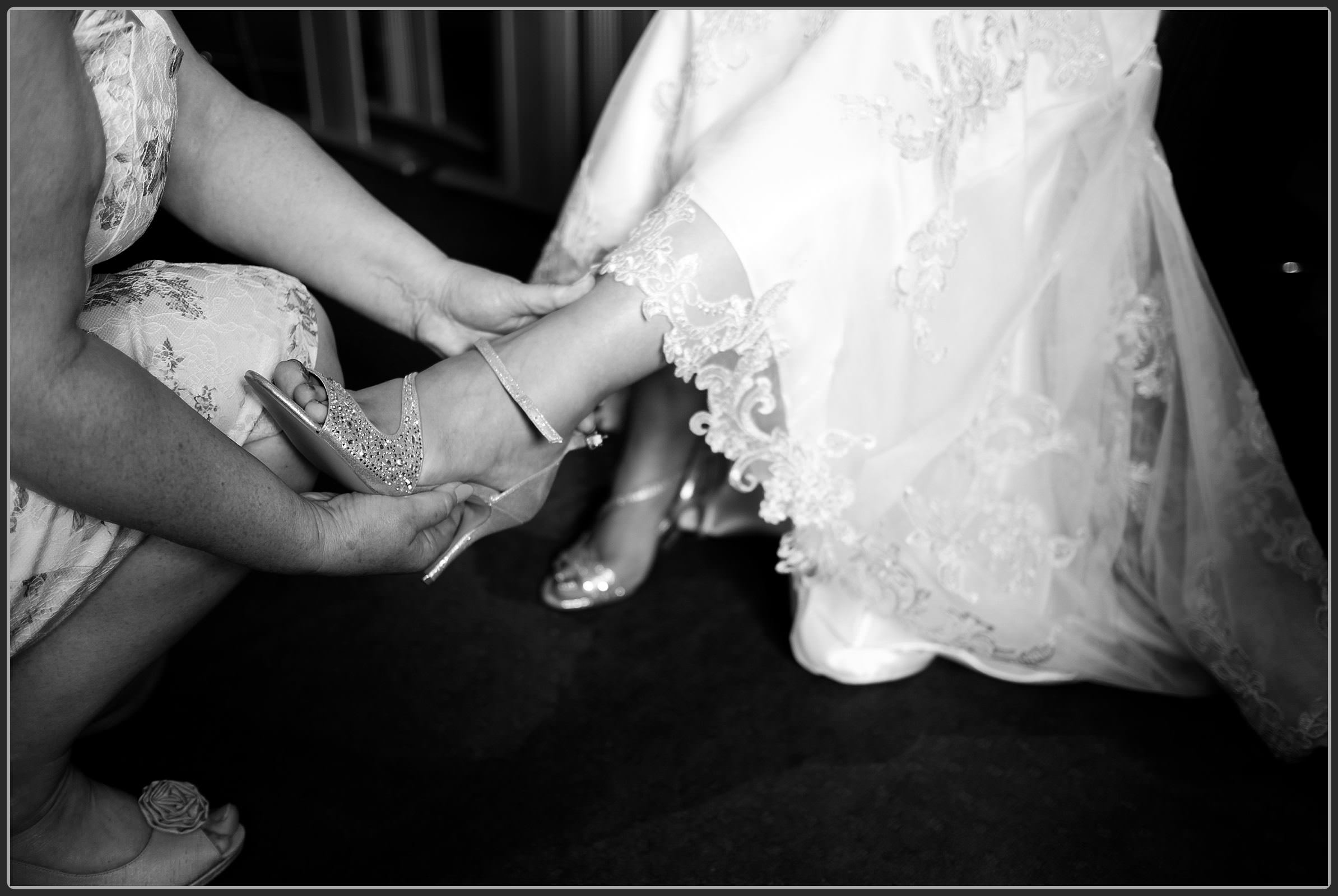 Bride putting her shoes on