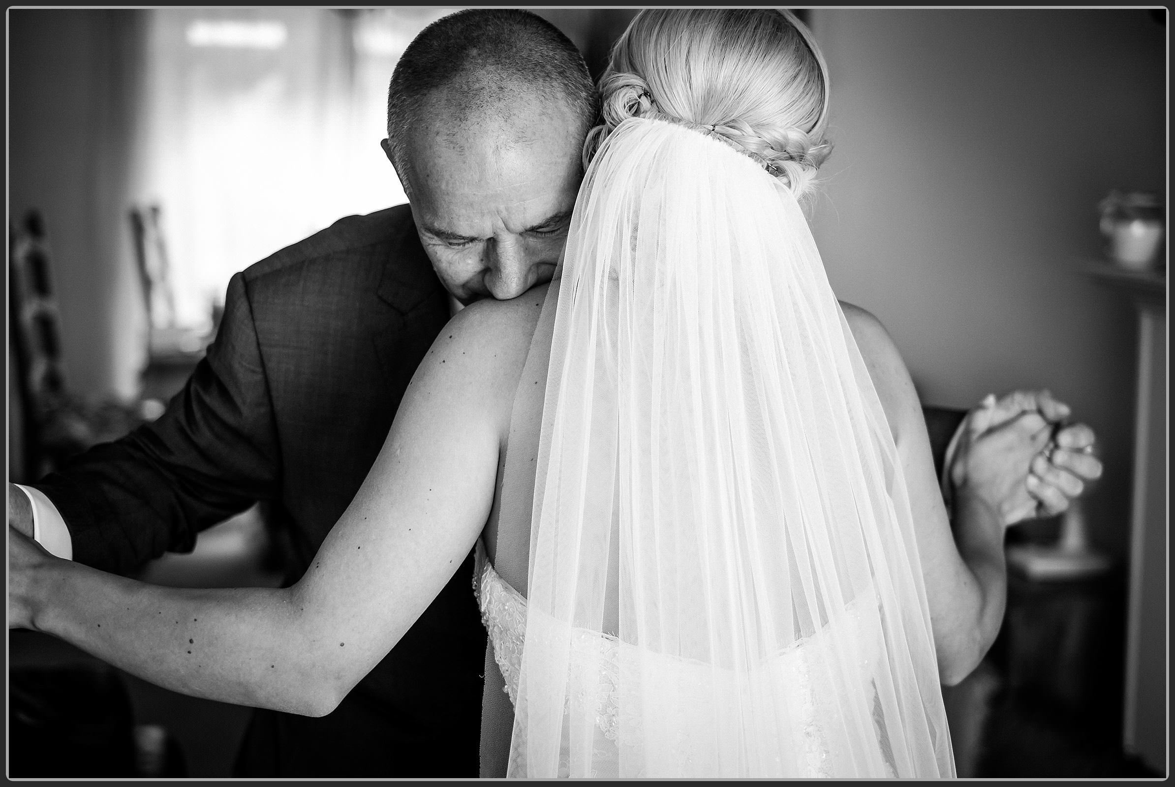 Father of the bride hugging her daughter