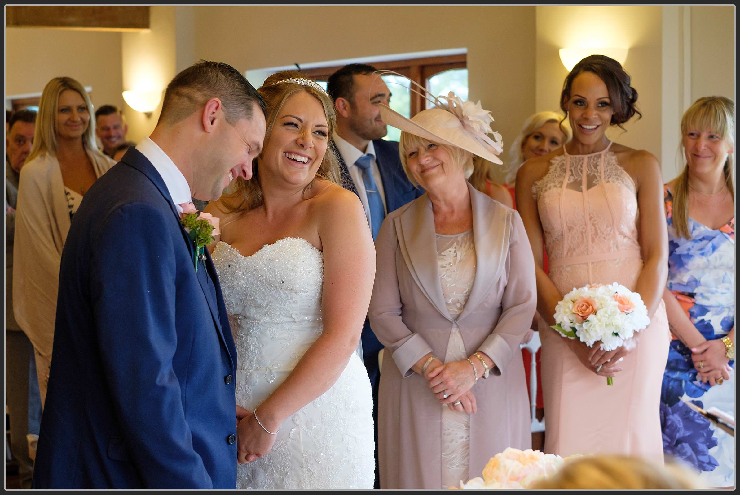 Bride and groom laughing during the ceremony