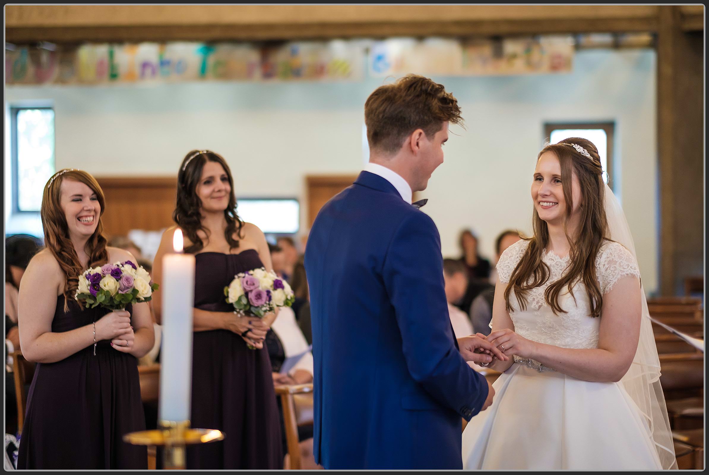 The bride and groom exchanging rings