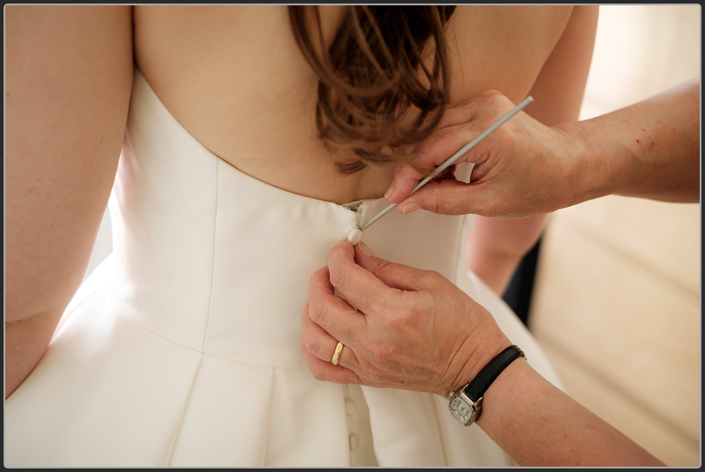 Bride getting into her wedding dress