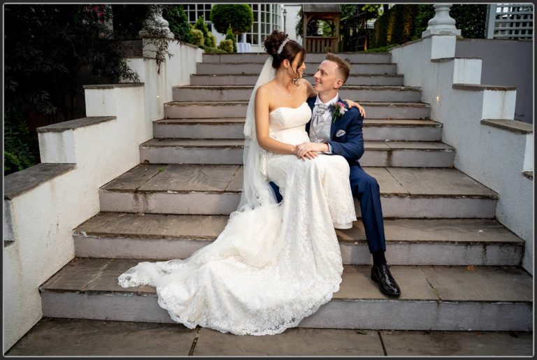 The Bride and Groom on the stairs at Warwick House