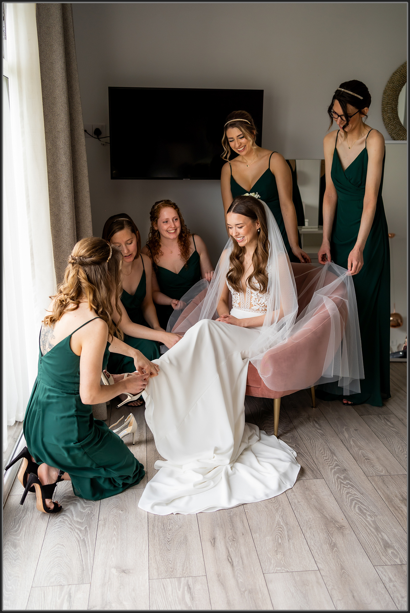 Bridesmaids helping the bride get ready