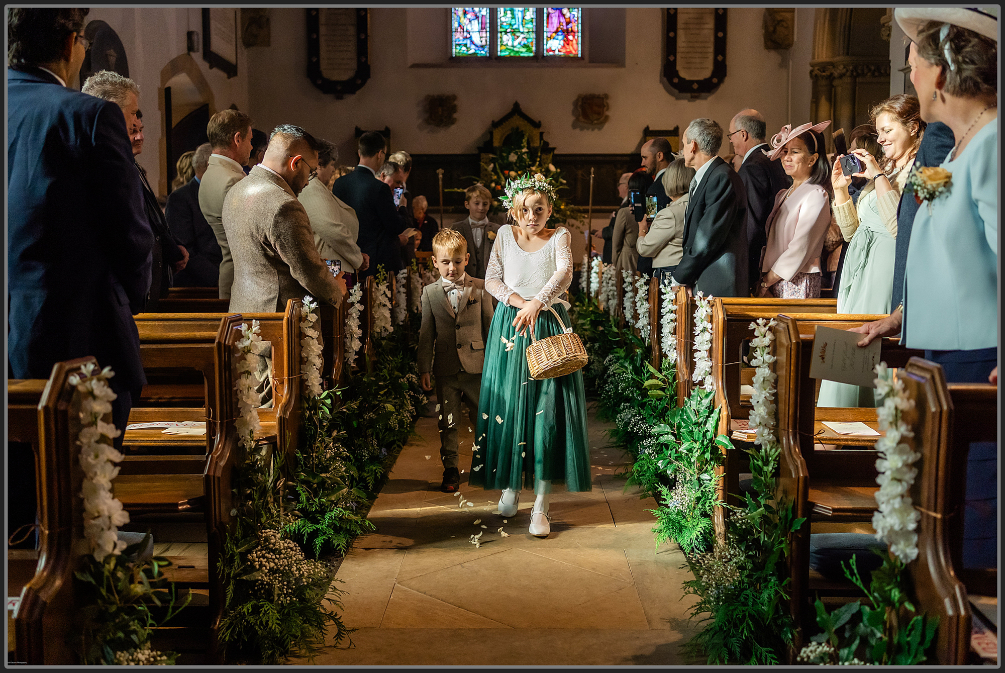 Flower girl and page boy walking down the aisle