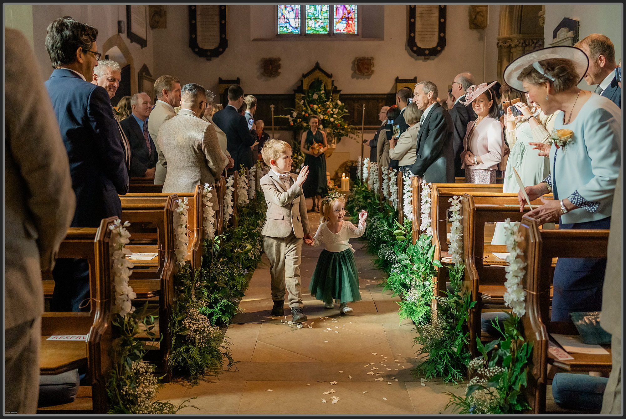 Flower girl and page boy walking down the aisle