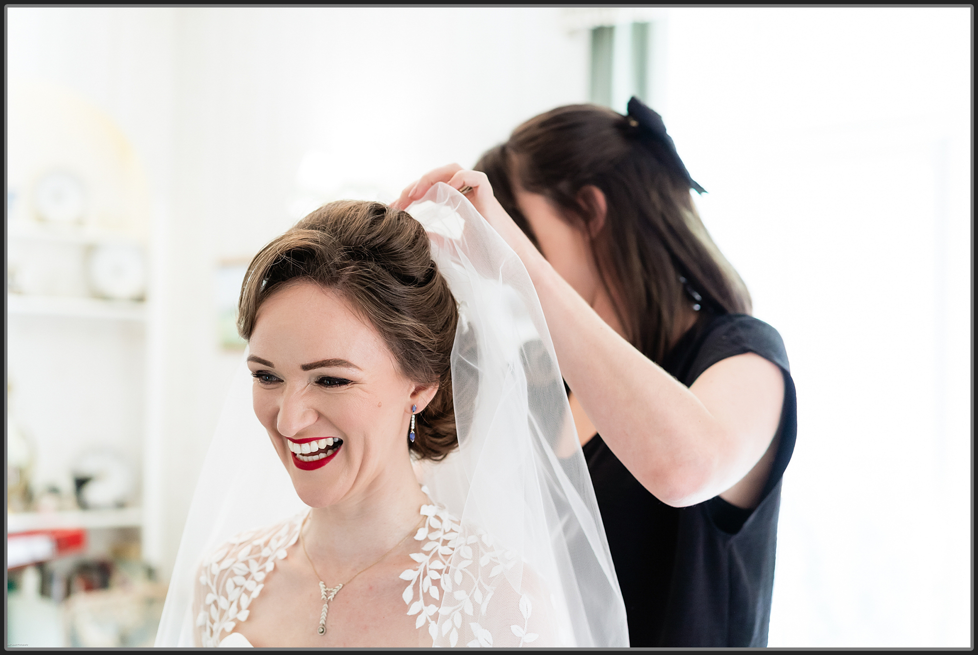 Bride having her veil put on