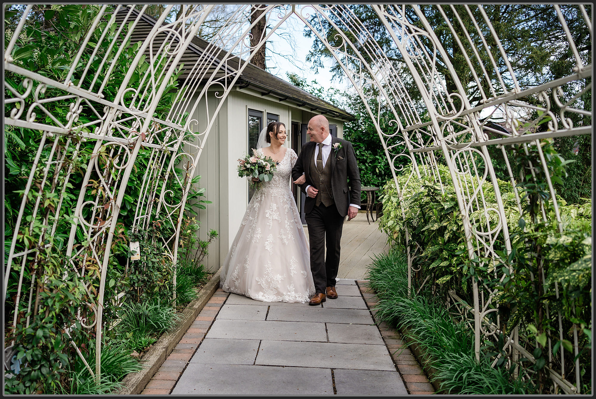 The bride and her father walking towards the wedding ceremony