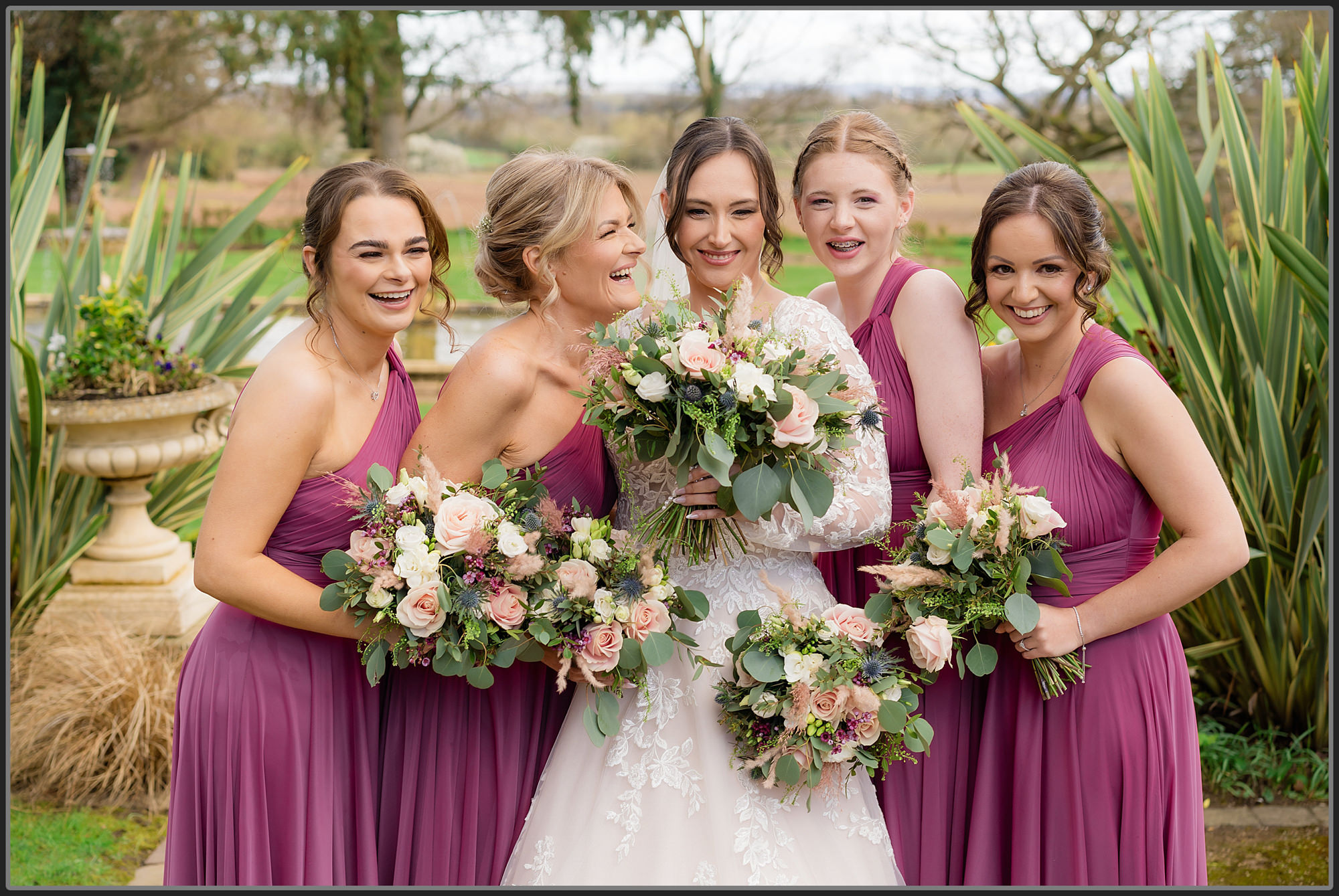 The bride and bridesmaids together in the grounds of Moxhull Hall Hotel