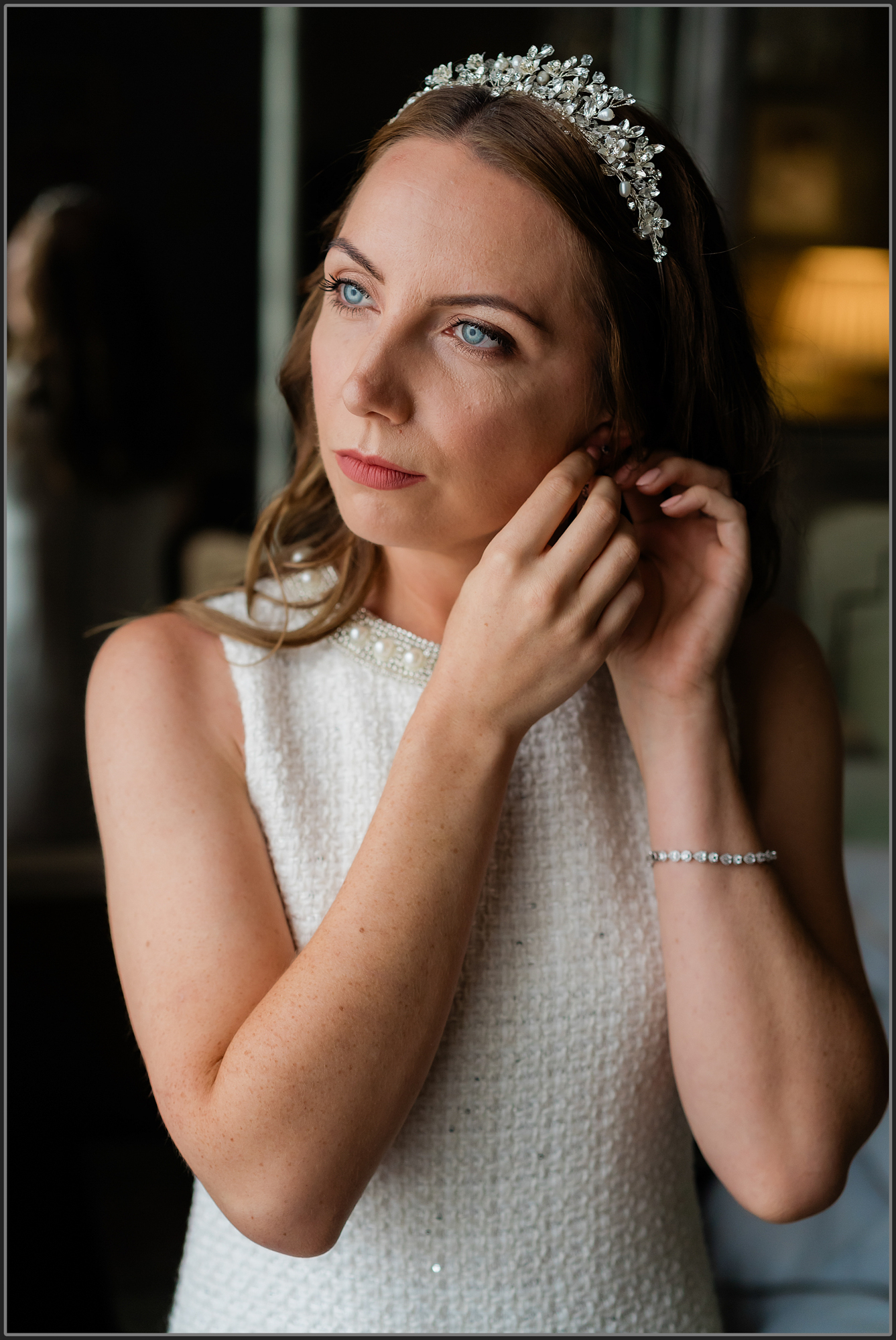 The bride putting her earrings in